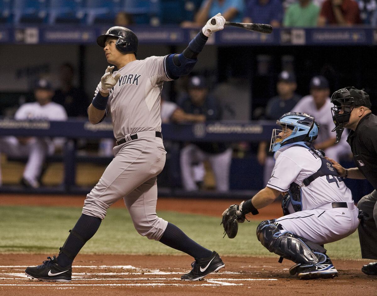 Yankees slugger Alex Rodriguez watches his solo home run against the Tampa Bay Rays in the first inning Monday.