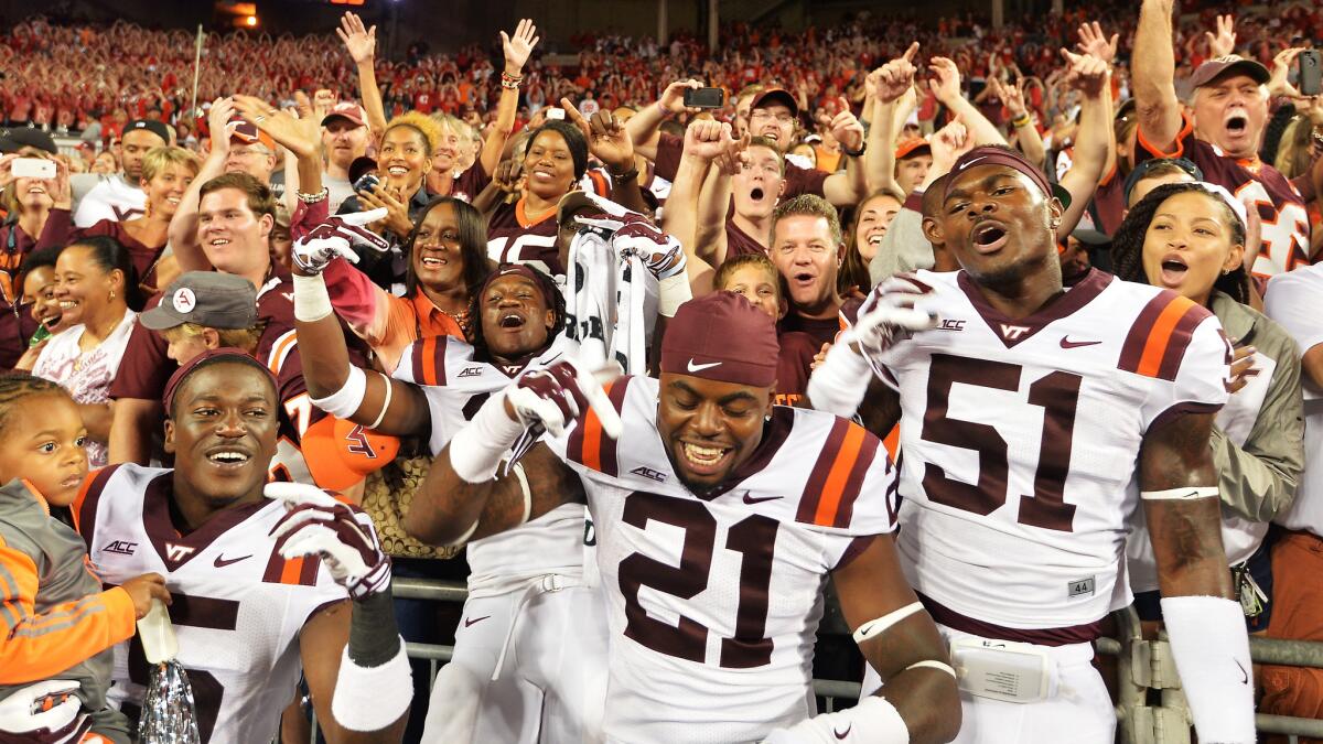 Virginia Tech players C.J. Reavis (21) and Melvin Keihn (51) celebrate the Hokies' 35-21 win over Ohio State on Saturday. Despite the win, Virginia Tech is still ranked below the Buckeyes in the USA Today coaches' poll.