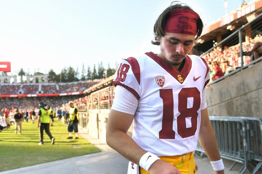 PALO ALTO, CALIFORNIA SEPTEMBER 8, 2018-USC quarterback J.T. Daniels looks at his throwing hand as he heads to the locker room during a game against Stanford at Stanford Stadium Saturday. (Wally Skalij/Los Angeles TImes)