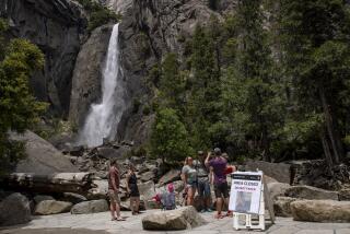 Visitors to Yosemite Valley take photographs at Lower Yosemite Falls