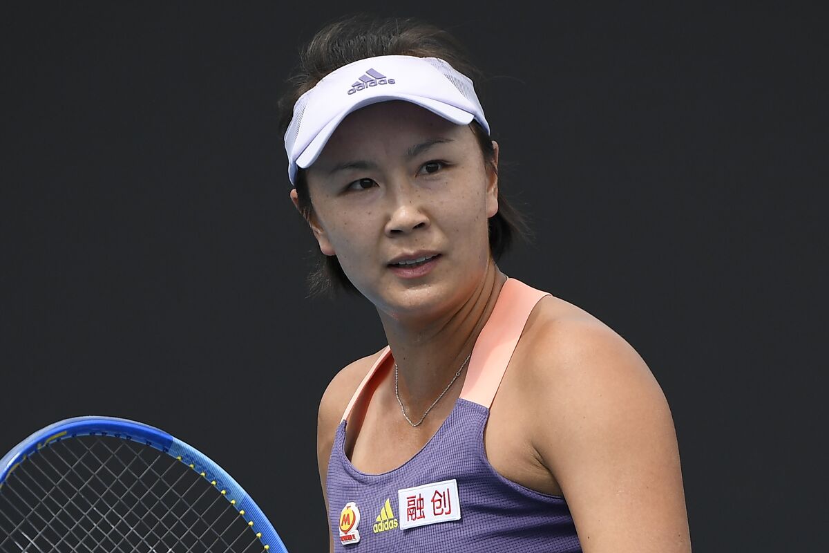 FILE - China's Peng Shuai reacts during her first round singles match against Japan's Nao Hibino at the Australian Open tennis championship in Melbourne, Australia on Jan. 21, 2020. The head of the women’s professional tennis tour announced Wednesday, Dec. 1, 2021, that all WTA tournaments would be suspended in China because of concerns about the safety of Peng Shuai, a Grand Slam doubles champion who accused a former high-ranking government official in that country of sexual assault. (AP Photo/Andy Brownbill, File)