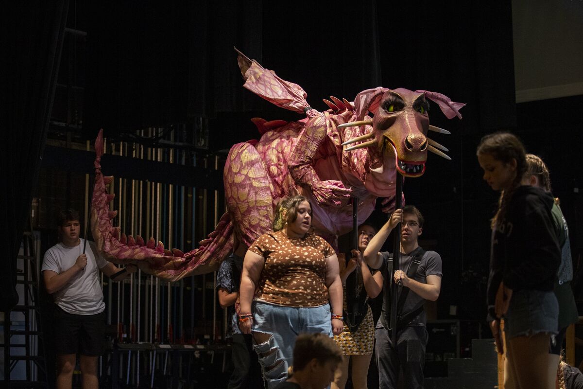 Lexy Rocha, center, rehearses her role as the dragon during Marina Youth Theatre's rehearsal for "Shrek the Musical" Monday.