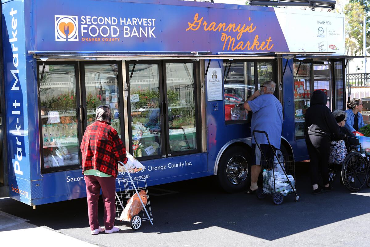 Seniors choose food from the Second Harvest Food Bank's mobile Granny's Market at Villa Anaheim.