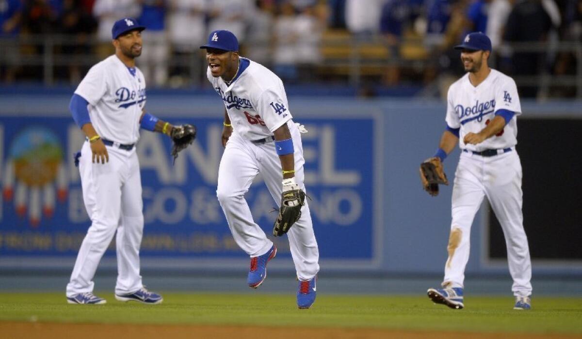 Rookie outfielder Yasiel Puig, center, is hitting .435 with seven home runs and 14 runs batted in for the Dodgers.