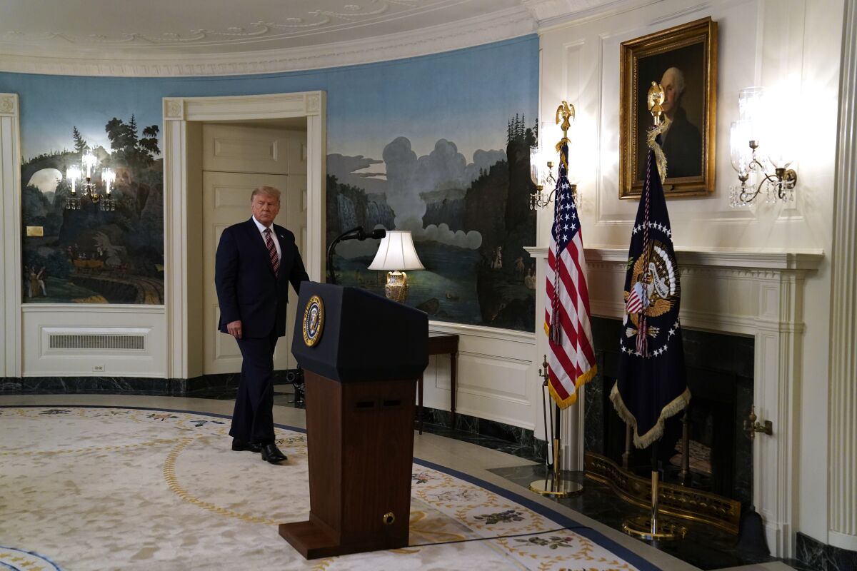 President Trump enters the White House Diplomatic Room on Wednesday, where he defended his downplaying of the coronavirus. 