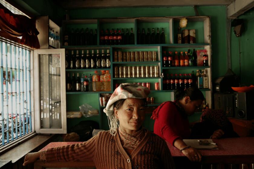 Two women work in a restaurant in Kodari, Nepal, a busy border town with China where many goods are coming into Nepal. China is pumping a lot of money into the economy. Two women work in a restaurant in Kodari.