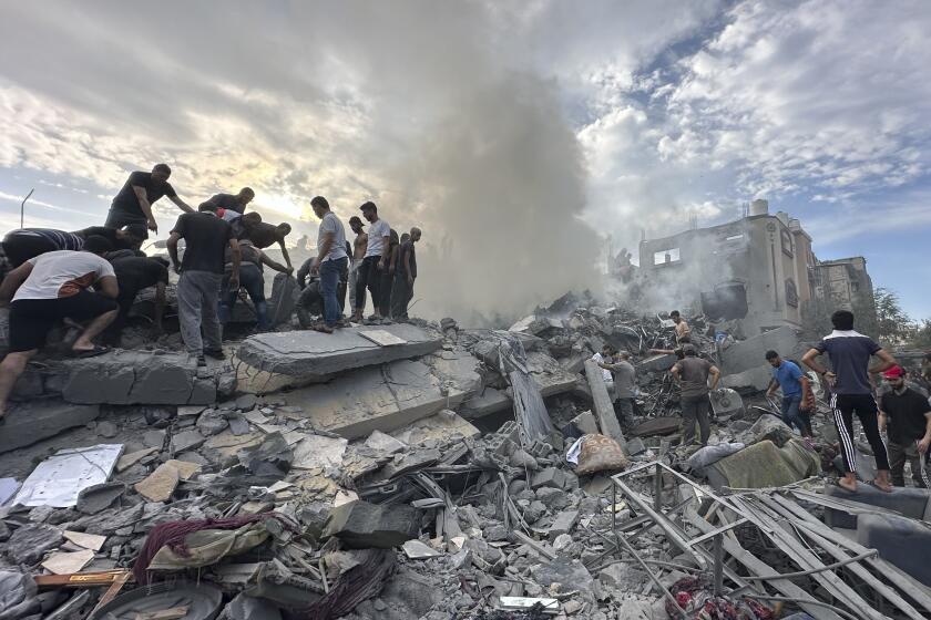 Palestinians look for survivors following Israeli airstrike in Nusseirat refugee camp, Gaza Strip, Tuesday, Oct. 31, 2023. (AP Photo/Doaa AlBaz)