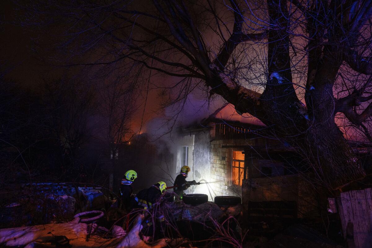 Firefighters extinguishing blaze at residence after Russian rocket attack on Kyiv