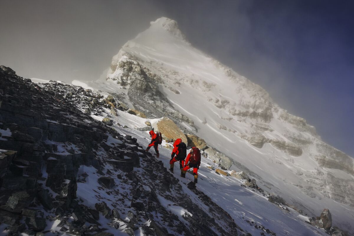 Members of a Chinese surveying team head for the summit of Mt. Everest. 