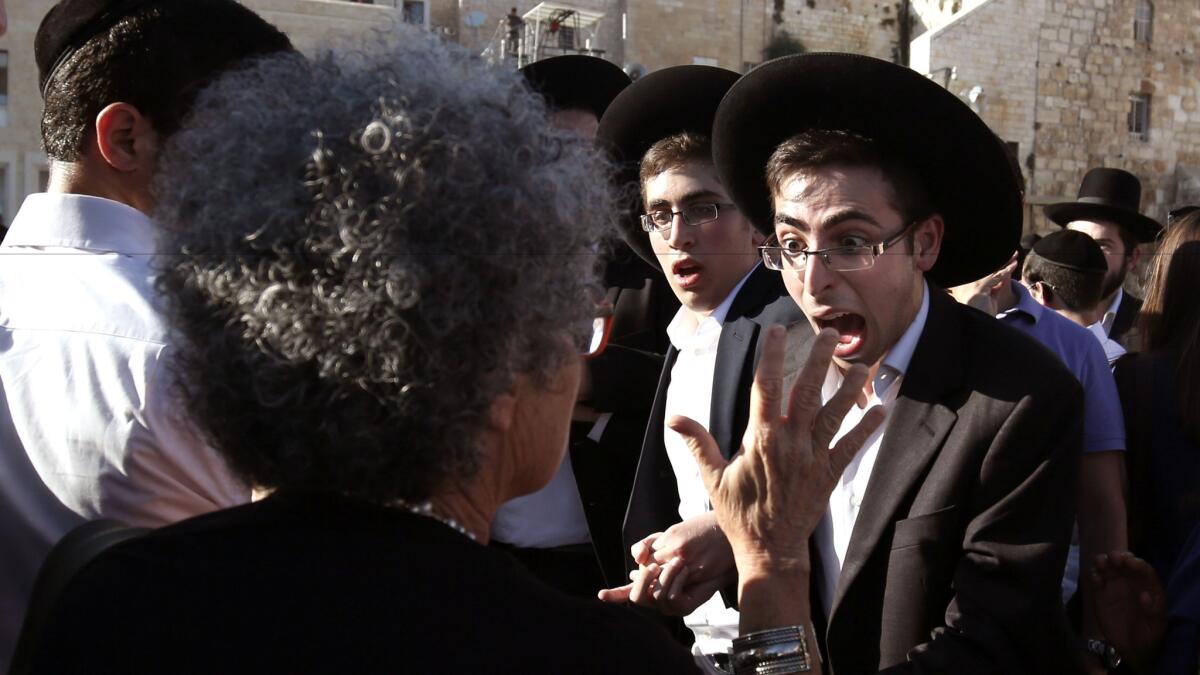 An Orthodox Jewish man yells at an woman advocating egalitarian prayer at the Western Wall in Jerusalem's Old City on June 16.