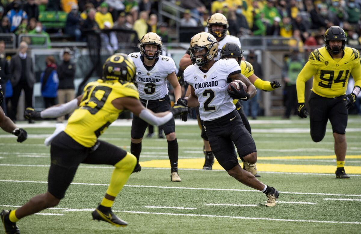 Colorado wide receiver Brenden Rice runs with the ball against Oregon in October.