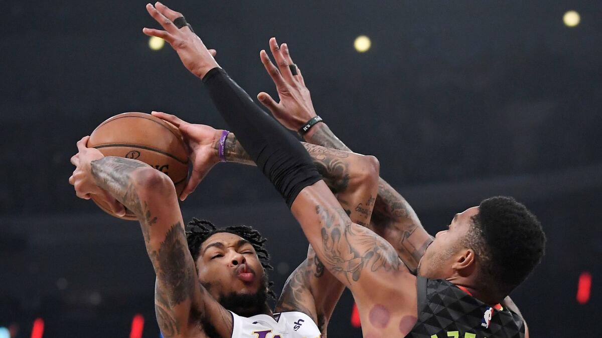 Lakers forward Brandon Ingram shoots against Atlanta guard Kent Bazemore on Jan. 7.