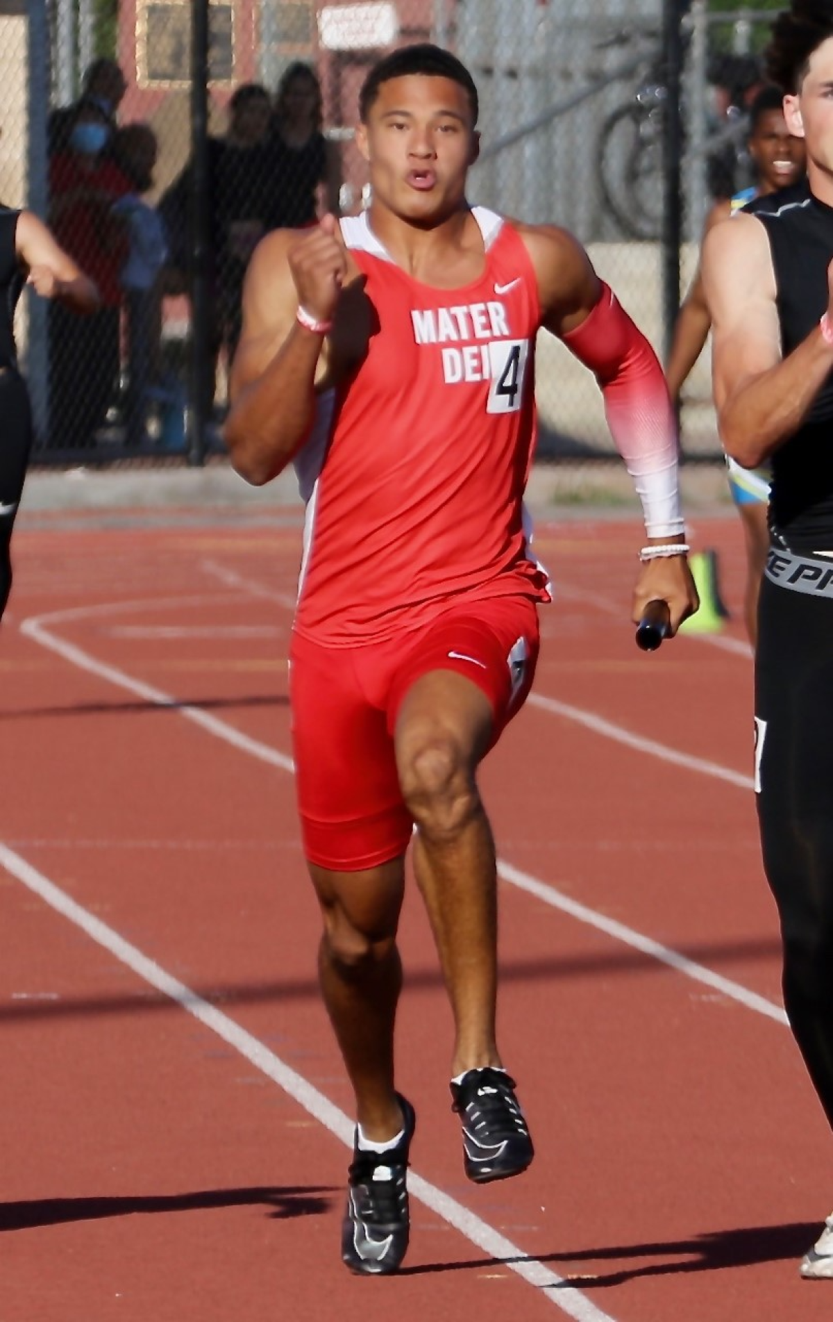 Domani Jackson of Mater Dei wins the 100-meter dash in 10.25 seconds, tying the state record.