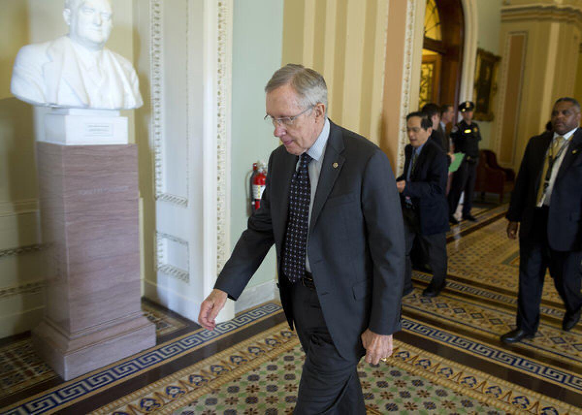 Senate Majority Leader Harry Reid leaves a caucus on Capitol Hill. Reid on Thursday announced that gun control legislation would be tabled for the time being.