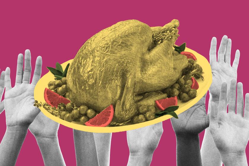 Yellow roast turkey on a platter with fruit held aloft by many hands against a cranberry background.