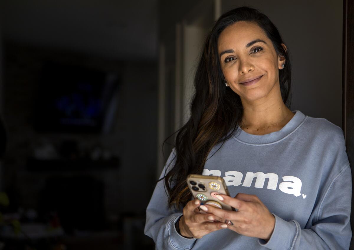 A woman holds her cellphone