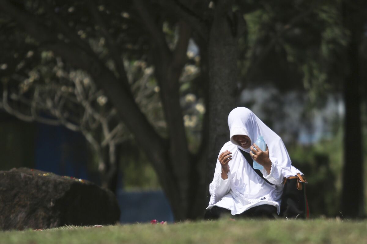 A woman prays Dec. 26 during the commemoration of the 15th anniversary of the Indian Ocean tsunami in Banda Aceh, Indonesia.