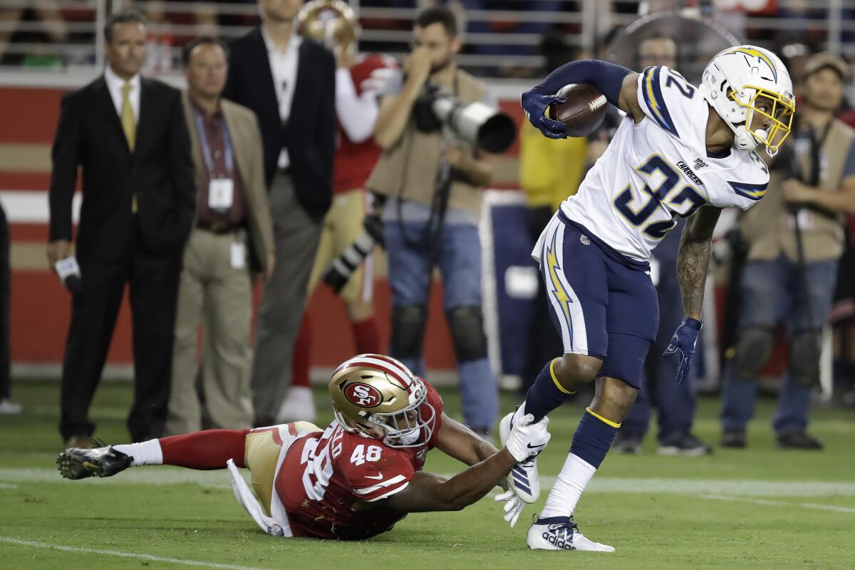 Chargers safety Nasir Adderley (32) intercepts a pass in front of San Francisco 49ers' Tyree Mayfield in 2019.