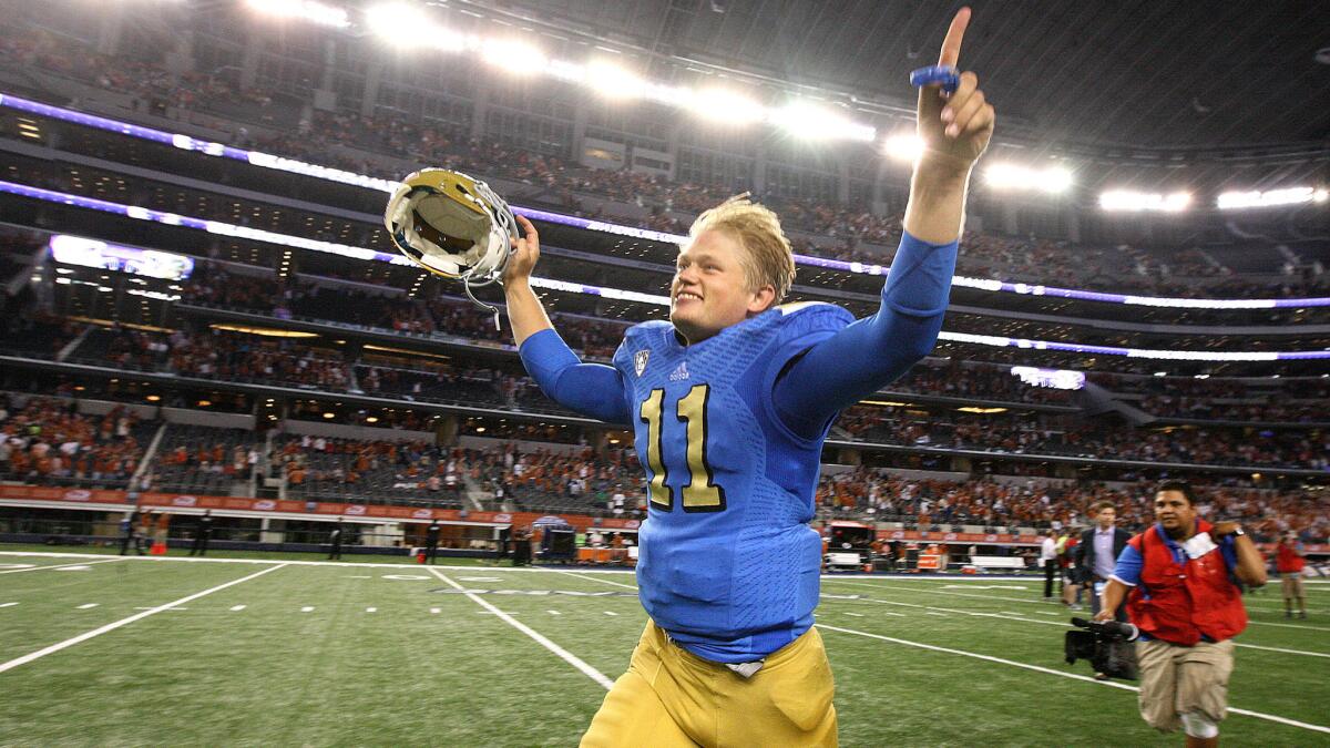 UCLA quarterback Jerry Neuheisel celebrates while running off the field following the Bruins' victory over Texas on Saturday.