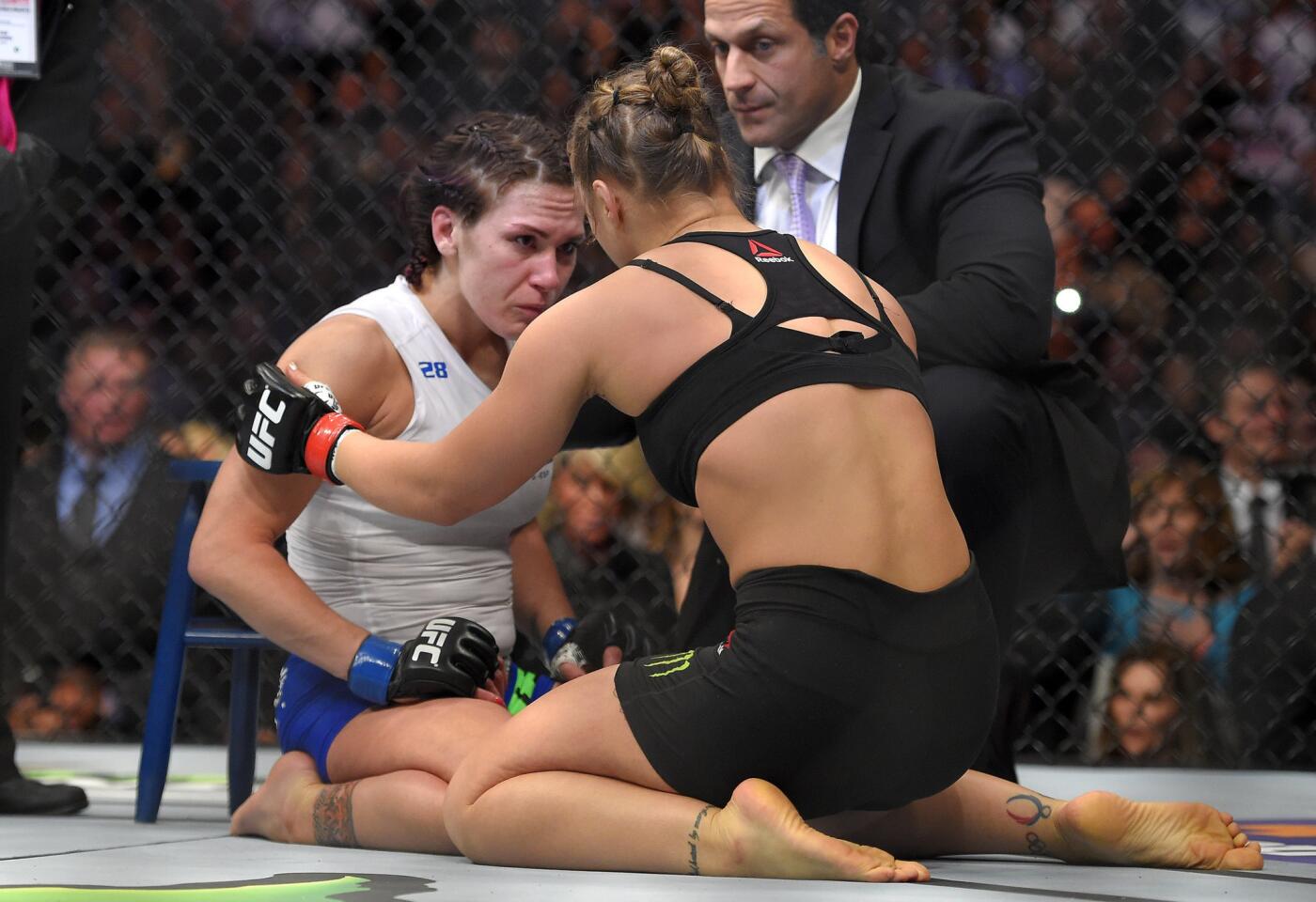 Ronda Rousey, right, consoles Cat Zingano, who tapped out 14 seconds into their UFC 184 bout Saturday at Staples Center.