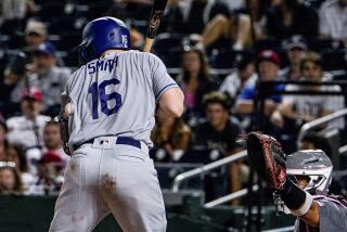 Los Angeles Dodgers' Will Smith is hit by a pitch during the eighth inning of the team's baseball game.