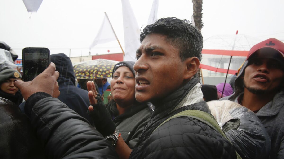 David Vasquez stood next to a group that attempted to march the La Chapparal at the Mexico-U.S. border to begin a hunger strike. Vasquez is among a group of caravan members trying to organize without creating any leaders.