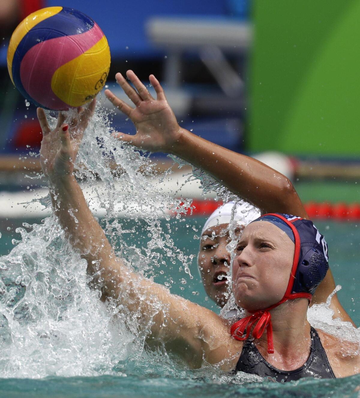 Kaleigh Gilchrist, foreground, and China's Donglun Song fight for possession during the U.S. women’s water polo team’s 12-4 victory Thursday at the Olympics in Rio de Janeiro.