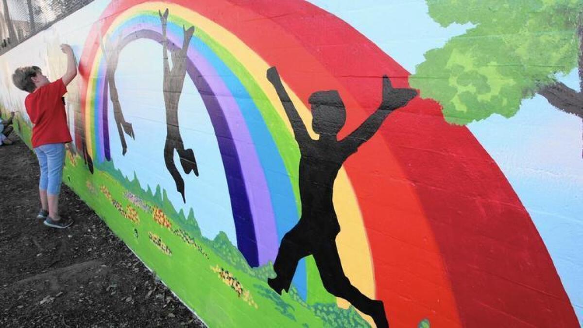 School children help paint a mural at Edison Elementary on Tuesday, fEB. 16, 2016.