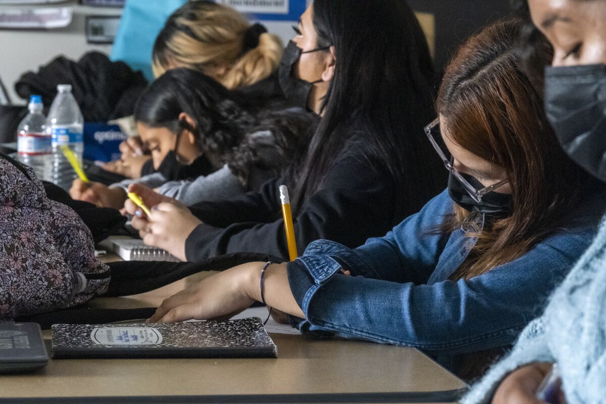 Students takes notes during a high school history class in Los Angeles.