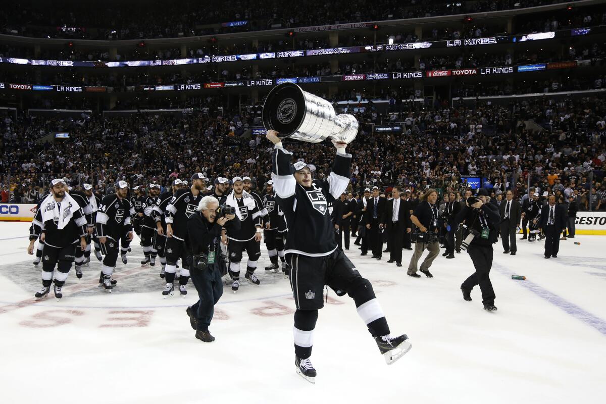Kings captain Dustin Brown skates with the Stanley Cup on June 13, 2014.