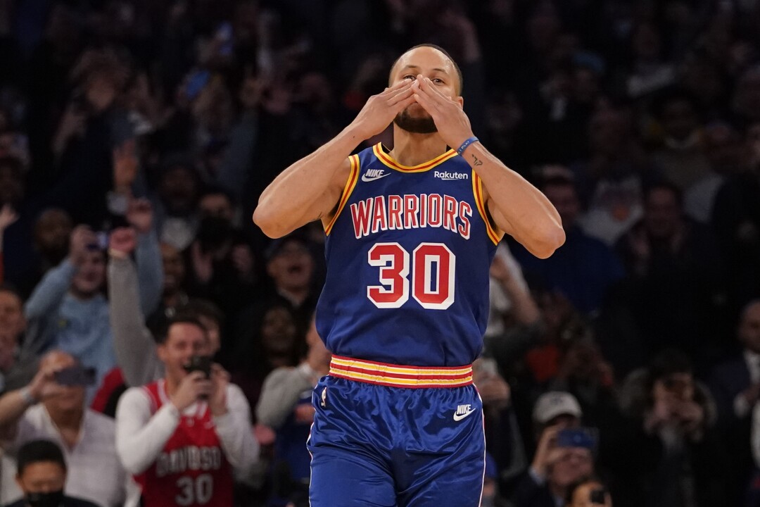 Golden State Warriors guard Stephen Curry blows a kiss at the fans after scoring a 3-point basket during the first half 