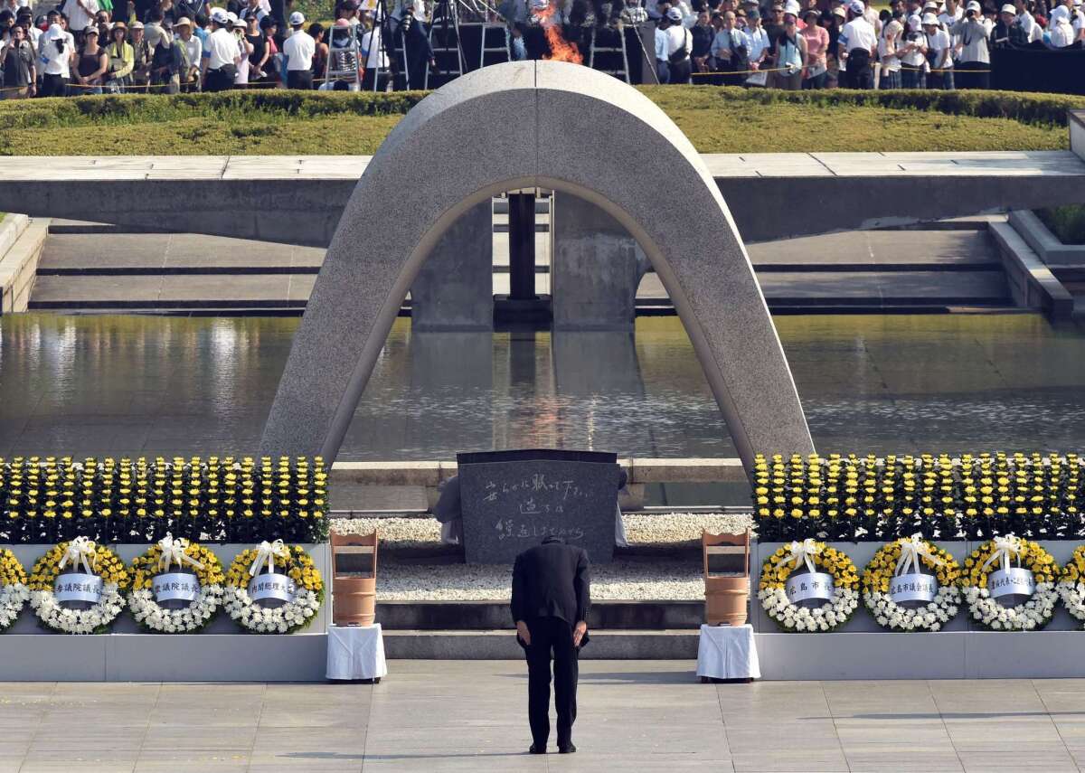 Japanese Prime Minister Shinzo Abe bows in front of the memorial cenotaph for victims of the 1945 atomic bombing at the Hiroshima Peace Memorial Park on Aug. 6.