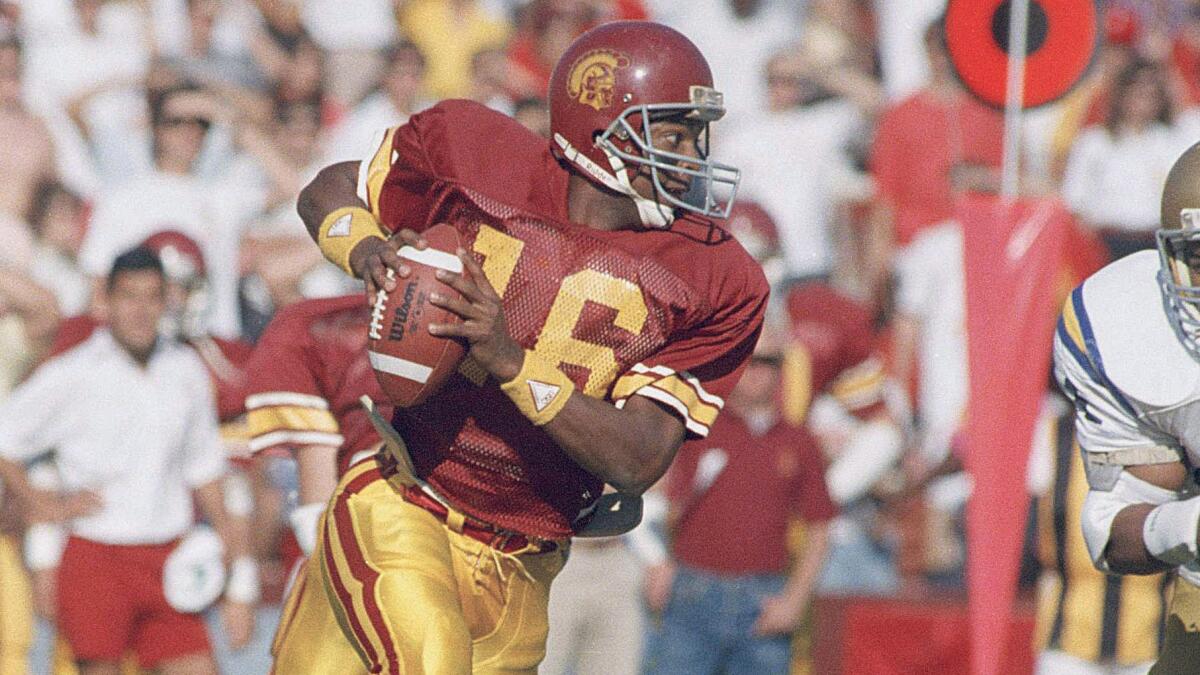 USC quarterback Rodney Peete runs with the ball during a game against UCLA at the Coliseum in November 1987. Peete wasn't too happy with how things went for the Trojans against Boston College on Saturday.