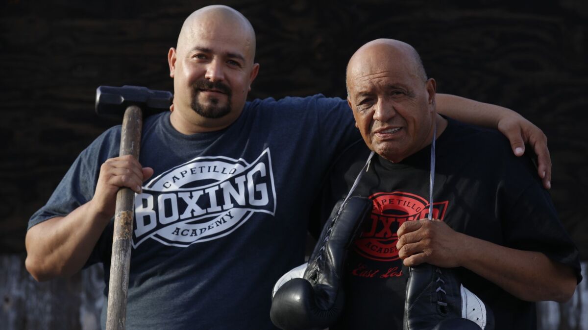 Javier Capetillo Jr., 41, left, and his father at Capetillo Boxing Academy in Los Angeles.