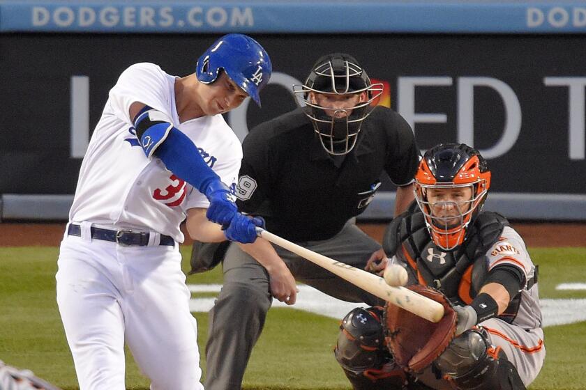 Dodgers center fielder Joc Pederson connects for a home run against the Giants in the bottom of the first inning Wednesday night.