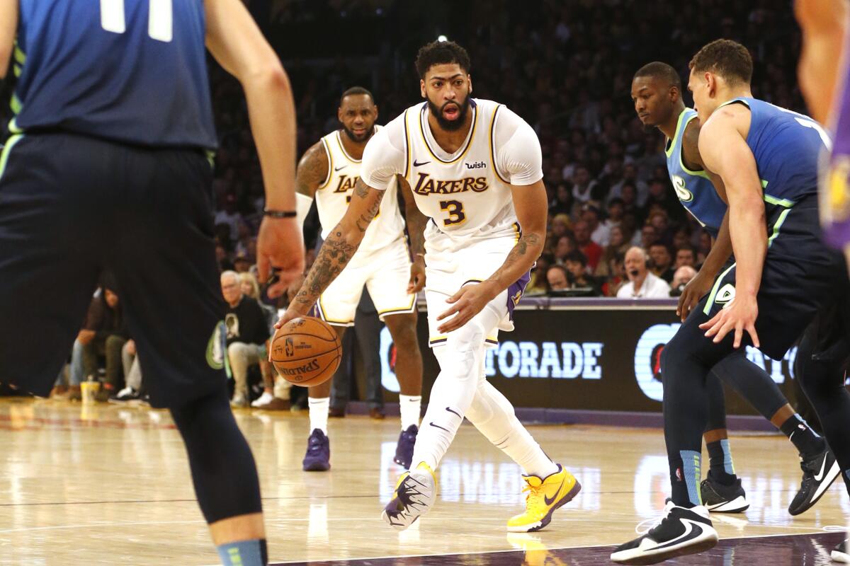 Lakers forward Anthony Davis controls the ball against the Mavericks.