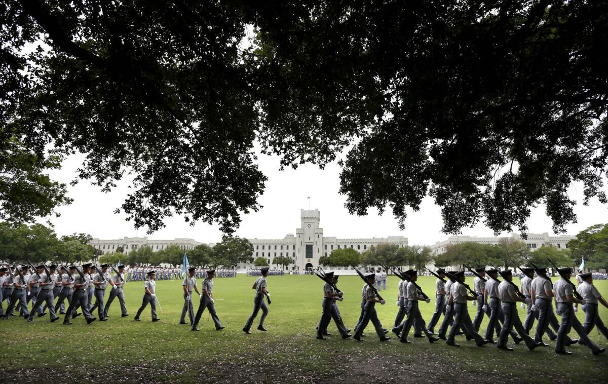 In this April 16, 2015 file photo, Citadel cadets practice for their weekly parade on the grounds of Summerall Field on the campus of The Citadel in Charleston, S.C.