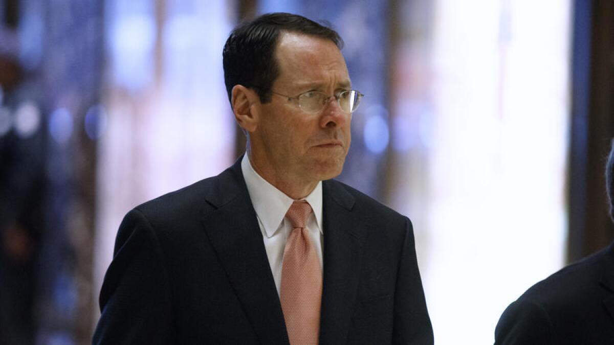 AT&T Inc. Chief Executive Randall Stephenson arrives in the lobby of Trump Tower in New York