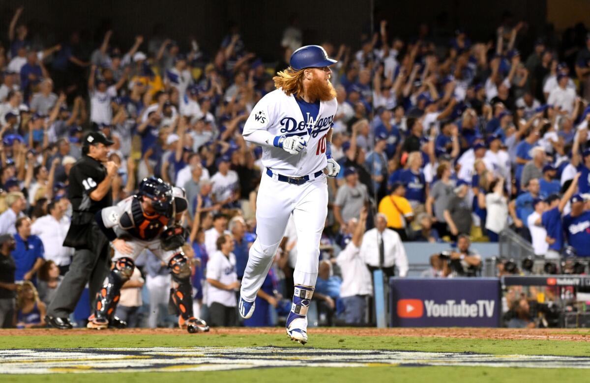 Justin Turner watches his two-run home run against the Astros during the sixth inning of Game 1.