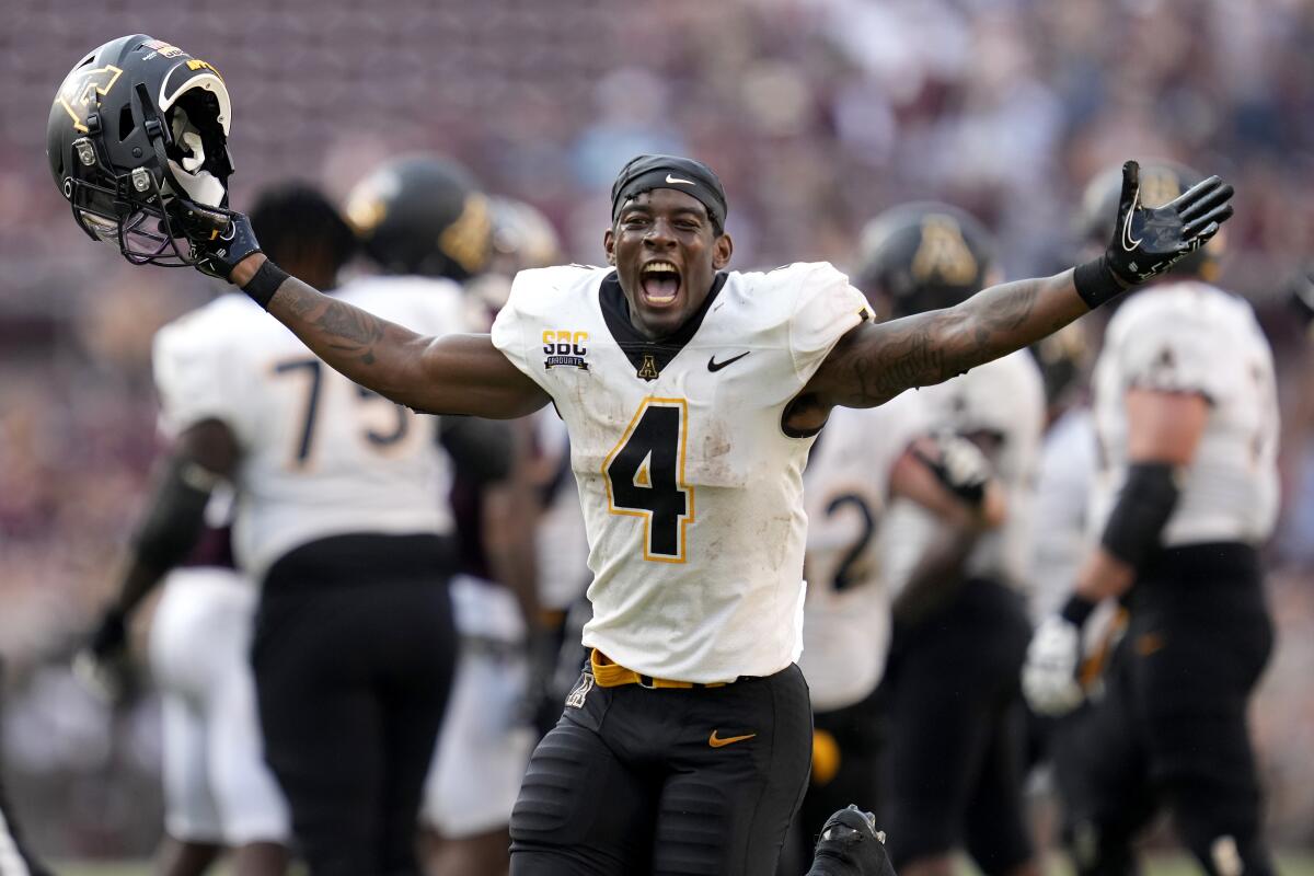 Appalachian State running back Daetrich Harrington (4) reacts as time expires after upsetting No. 6 Texas A&M in an NCAA college football game Saturday, Sept. 10, 2022, in College Station, Texas. (AP Photo/Sam Craft)