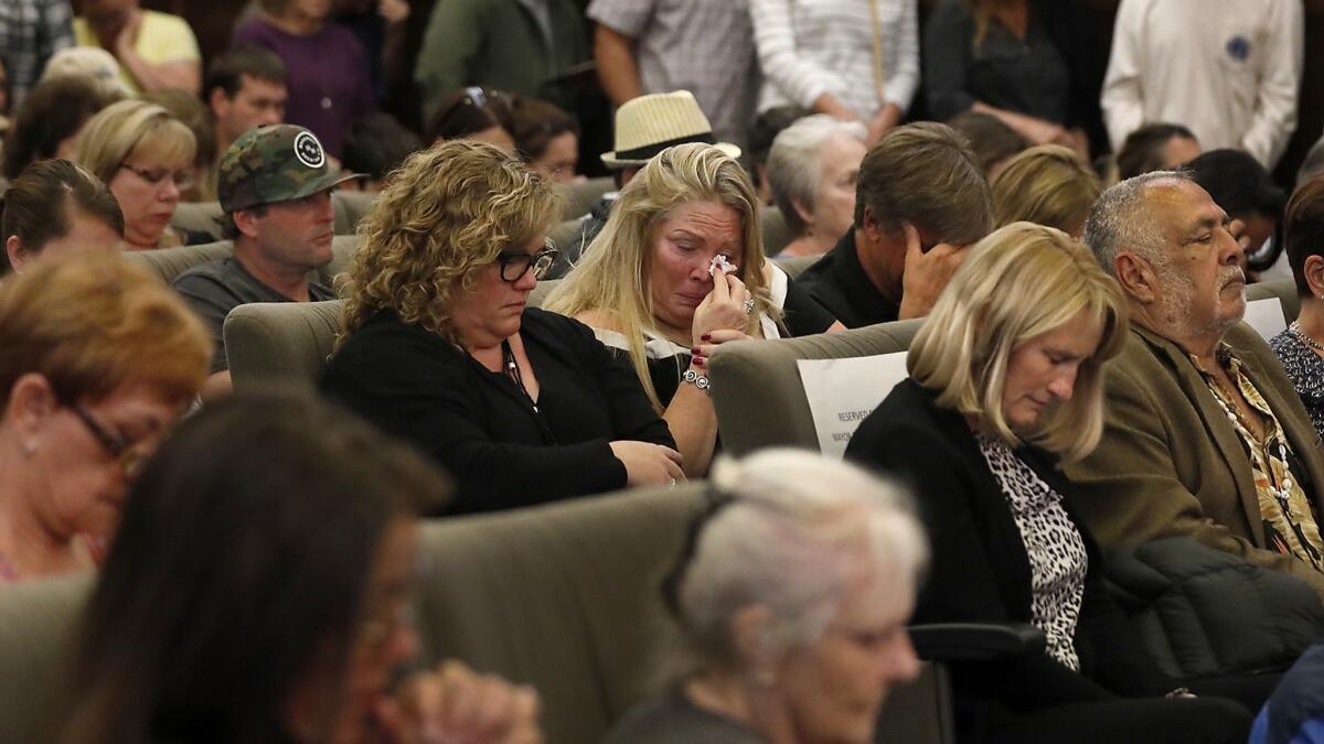 Charnell Smith, center, co-owner of Aloha Steakhouse in Ventura, wipes away tears during a moment of silence at Ventura City Hall for Anthony Mele Jr., 35, who was stabbed to death in the restaurant.