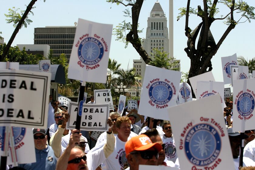 Union members and Department of Water and Power workers gather for a protest over funding for two nonprofit trusts outside the DWP in June 2014.