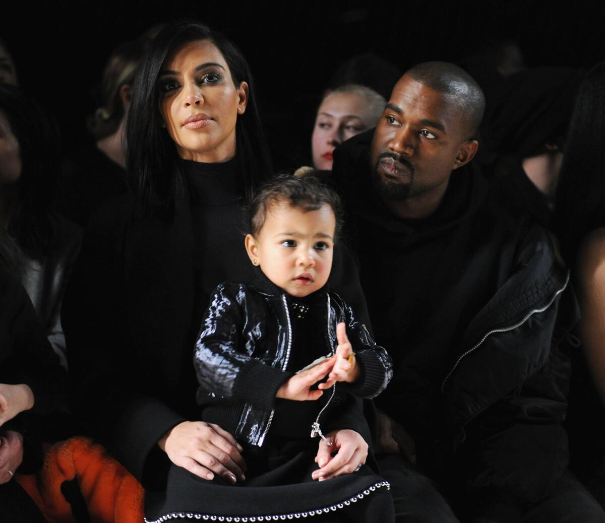 Kim Kardashian with daughter North West and husband Kanye West at Alexander Wang's New York Fashion Week Show this month.