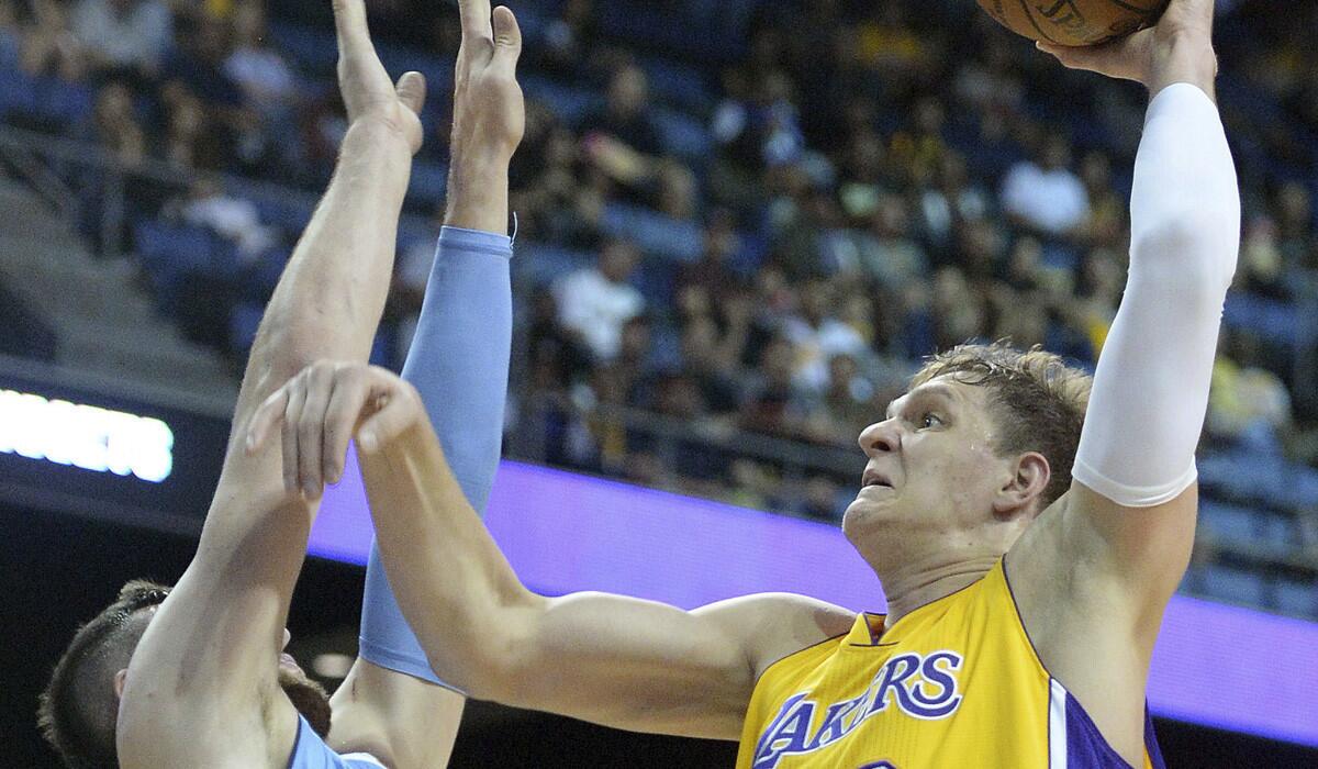 Lakers' Timofey Mozgov scores over Denver's Jusuf Nurkic.