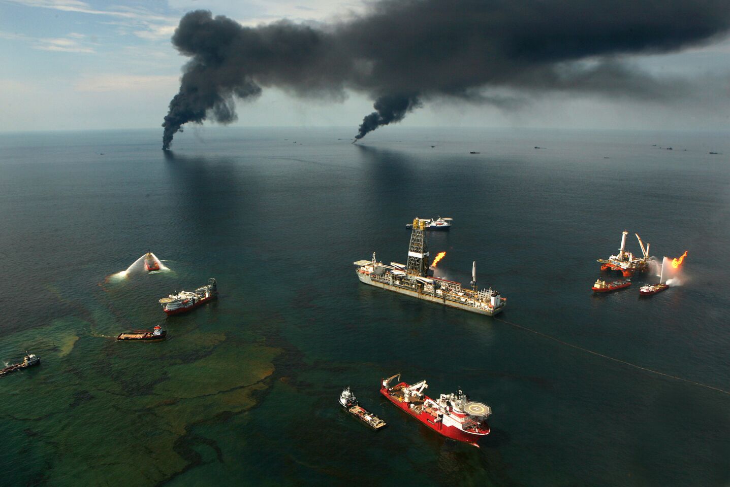 Black smoke rises from pockets of crude being burned in June 2010. Controlled burns removed 11.14 million gallons of oil, The Times found.