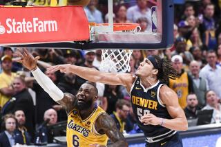 DENVER, CO - MAY 18: Los Angeles Lakers forward LeBron James, left, shoots as Denver Nuggets forward Aaron Gordon.