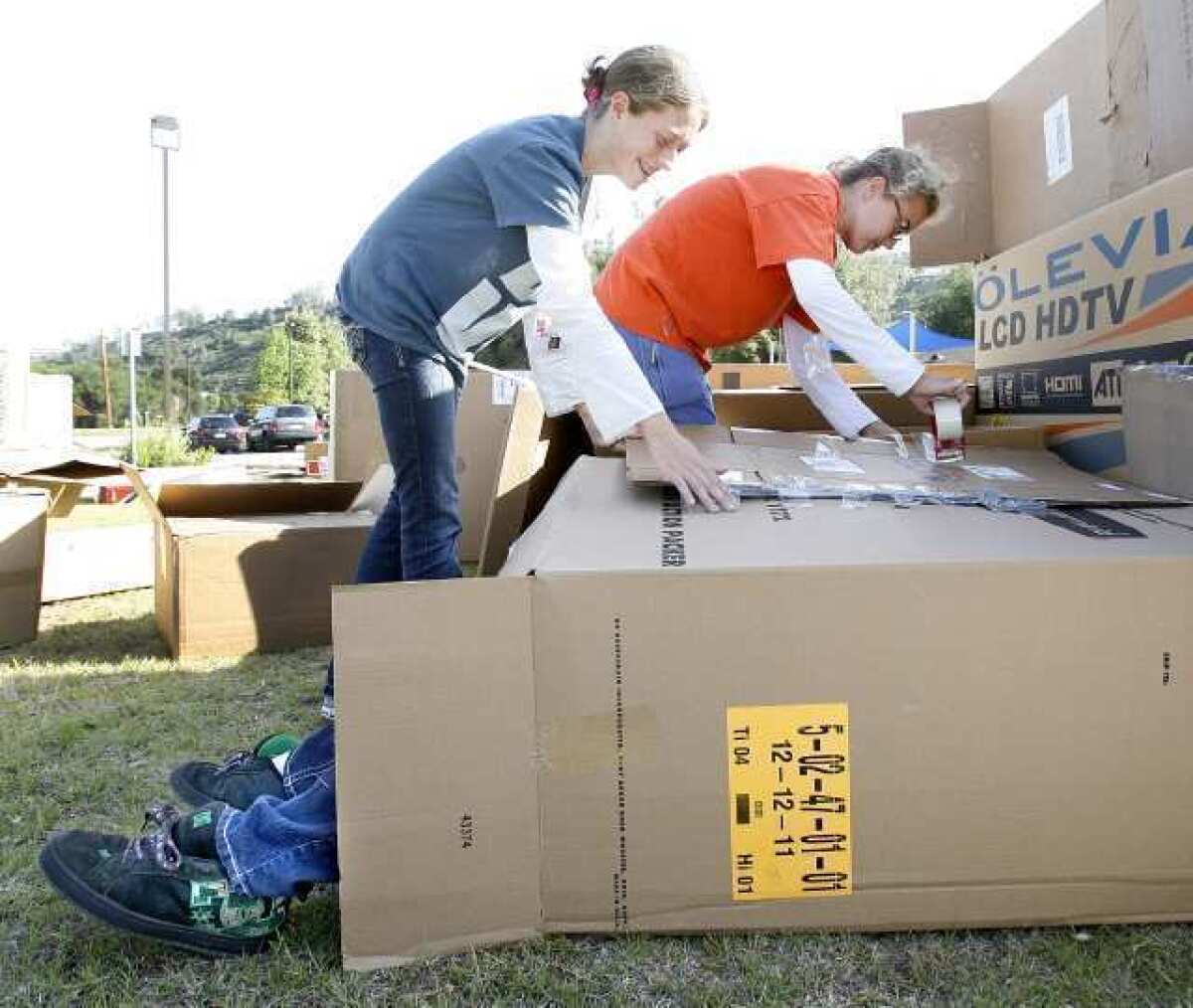 Emily Hirsch, 16, and Olivia Brandt, 14, tape boxes into place on the box city they helped create at La Canada United Methodist Church where a box city was set up for kids to get an authentic feeling of what it's like to be hungry and sleeping in a home of cardboard. The kids are participating in a 30-hour fast as part of World Vision 30 Hour Famine as a fundraiser with the goal of making $3,600.