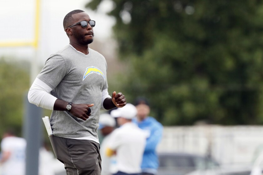 Chargers special teams coordinator Derius Swinton runs onto the field during practice