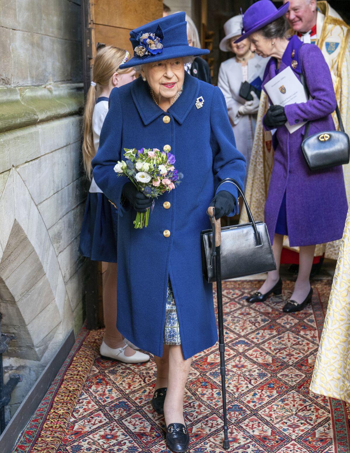 Britain's Queen Elizabeth II, followed by Britain's Princess Anne, right, arrives to attend a Service of Thanksgiving to mark the Centenary of the Royal British Legion at Westminster Abbey, in London, Tuesday, Oct. 12, 2021. (Arthur Edwards/Pool Photo via AP)