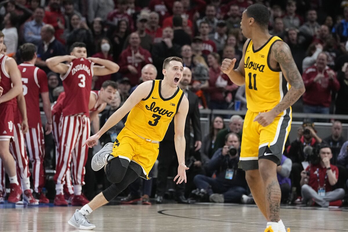 Iowa's Jordan Bohannon (3) celebrates after hitting the game-winning shot during the second half of an NCAA college basketball game against Indiana of an NCAA college basketball game in the semifinal round at the Big Ten Conference tournament, Saturday, March 12, 2022, in Indianapolis. (AP Photo/Darron Cummings)